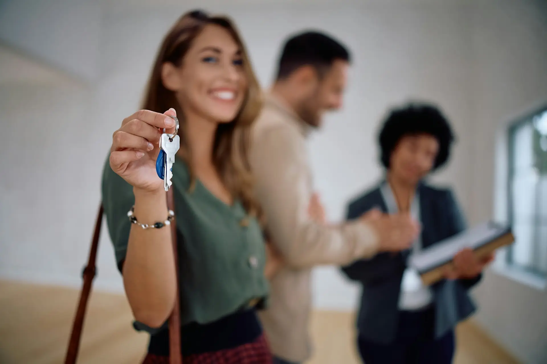 Close up of woman holding keys of her new house.